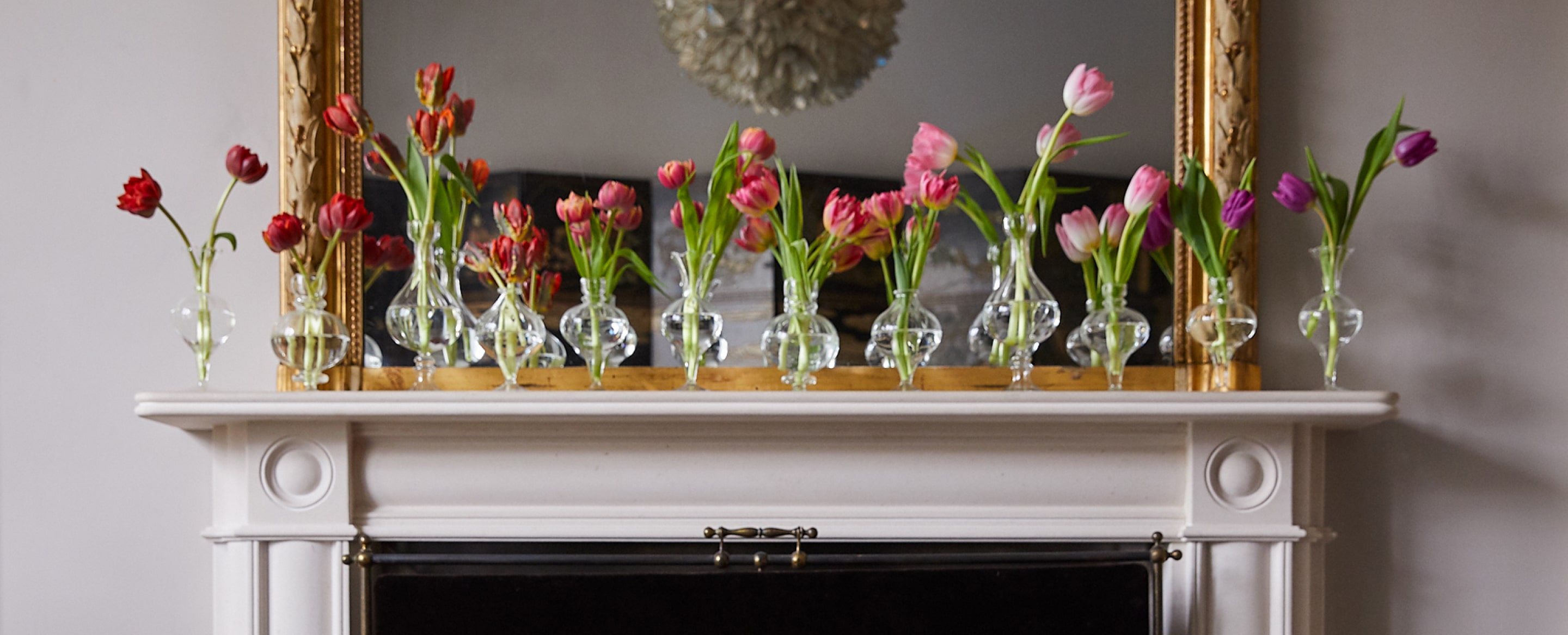 Flowers in a vase on a mantle piece